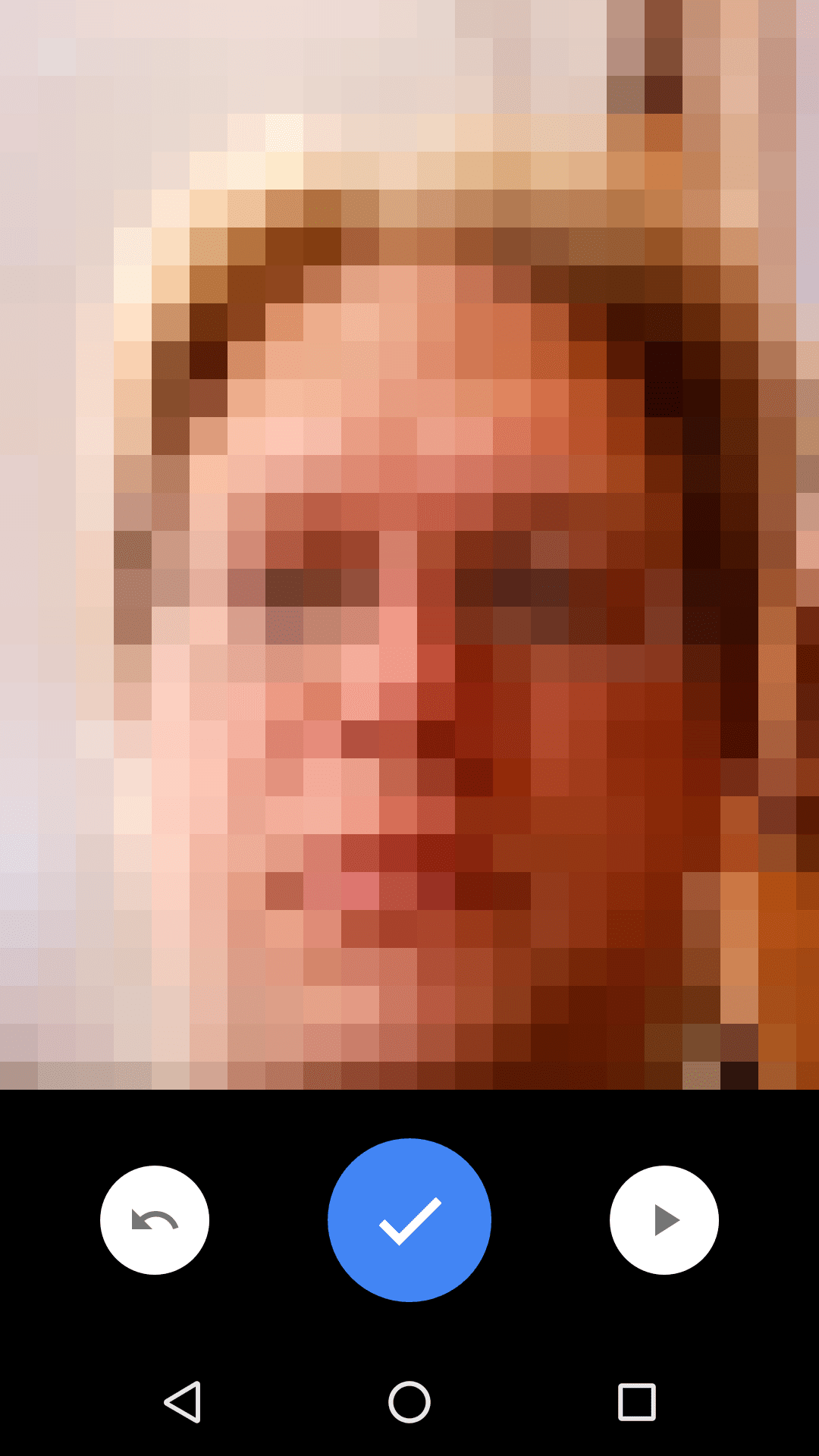 The Android camera app, in video mode. A person's face is in the camera viewer. Below the camera viewer is a large, blue checkmark button.
